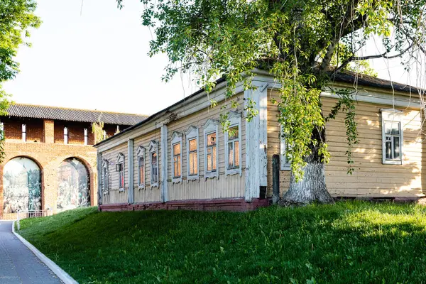 Kolomna, Rusya - 9 Haziran 2022: Eski Kolomna şehrinde güneşli bir yaz akşamında Kolomna Kremlin 'in Yamskaya Kulesi' nin antik kalesi yakınlarındaki eski ahşap şehir evi.