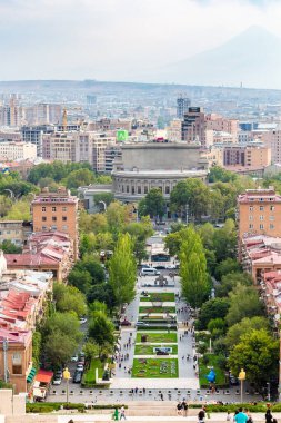 Yerevan, Armenia - September 29, 2023: view of green Tamanyan street and Yerevan opera house from Cascade stairs in Yerevan city in autumn twilight clipart