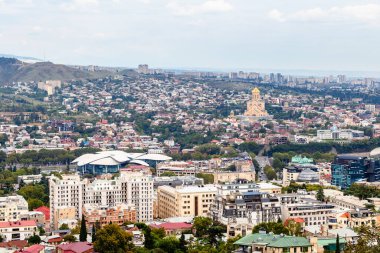 travel to Georgia - above view of Tbilisi city with Sameba church from Mount Mtatsminda on autumn day clipart