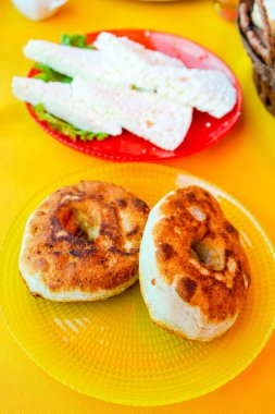 travel to Georgia - Georgian mchadi fried cornbread close up and brine cheese in local cafe in Signagi town in Kakheti region in Georgia clipart