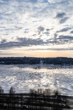 above view of ice floes on river in Kostroma city on winter evening