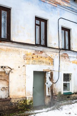 facade of shabby apartment house in Kostroma city on winter day
