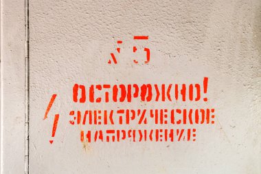 Kırmızı boya işareti. Dikkat! Kapalı elektrik kutusu kapısında Rusça 'da elektrik voltajı