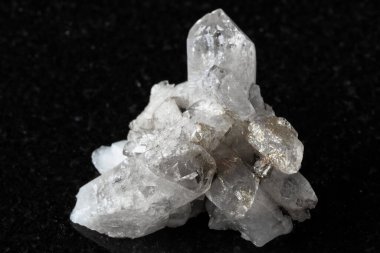 Siyah granit arka planda saf kuvars kristalleri numunesi yakın plan