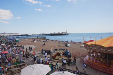 İnsanlar Brighton Sahili ve Gezinti Güvertesi 'nin tadını çıkarıyor. Doğu Sussex, İngiltere