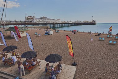 İnsanlar Brighton Sahili ve Gezinti Güvertesi 'nin tadını çıkarıyor. Doğu Sussex, İngiltere