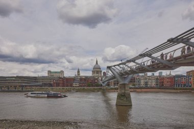 View of Millennium Bridge and London skyscrapers, United Kingdom.