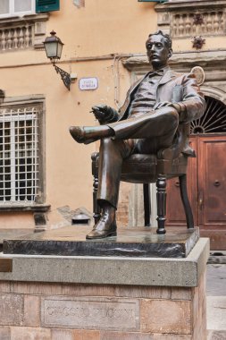 The bronze statue of Giacomo Puccini is in a square in his hometown in Tuscany. Lucca, Italy