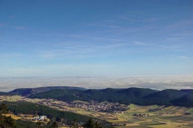 dense fog on the horizon with blue sky during hiking in the winter