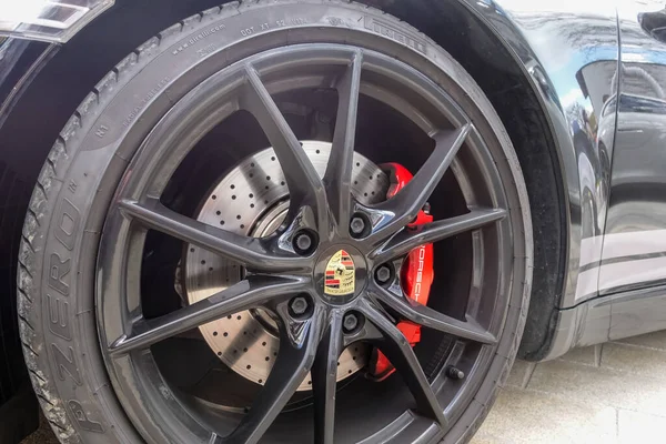 stock image wheel from a sports car in black with a red brake during a car show