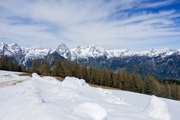 lot of snow and a snowy mountain range during hiking in upper austria in spring
