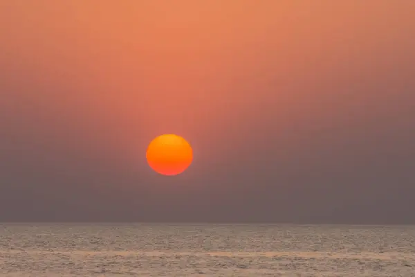 red orange sun over the sea on vacation in the summer of egypt