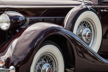 Yazın bir araba fuarı sırasında yedek lastiği olan çok eski klasik bir arabanın orta manzarası.