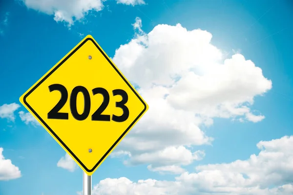 Three-dimensional rendering of road sign 2023 on the blue sky represents the new year 2023, 3D illustratio