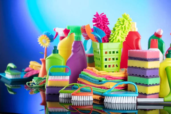 House  and office cleaning products. Colorful cleaning kit on blue background.
