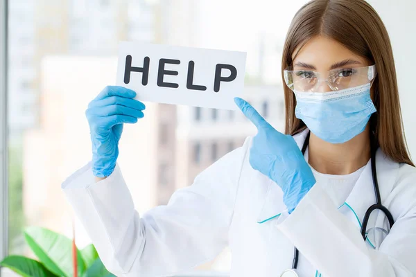 stock image Doctor or nurse showing help sign in office.