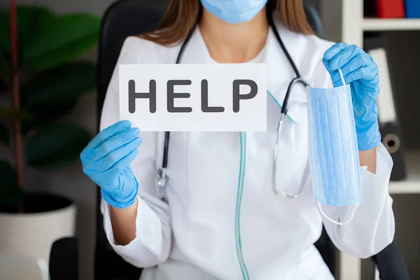 stock image Doctor or nurse showing help sign in office.