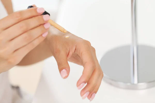 stock image Happy woman doing routine skin care at home with beauty products