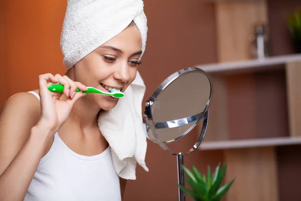 Healthy white teeth, portrait of beautiful young woman brushing teeth.