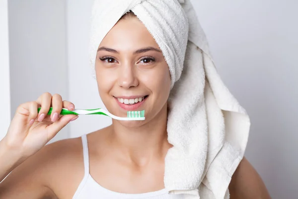 Healthy white teeth, portrait of beautiful young woman brushing teeth.