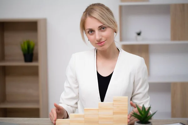 stock image Woman hand arranging wood block stacking as step stair