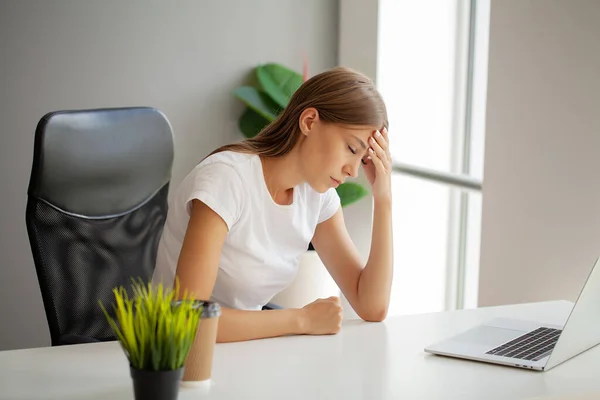 stock image Woman massaging temples, suffering from headache after computer work.