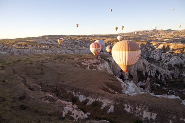 Cappadocia hot air baloon trip, Turkey. Tourists on board Hot air baloons are flying over Cappadocia