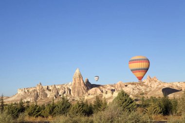 Cappadocia hot air baloon trip, Turkey. Tourists on board Hot air baloons are landing in Cappadocia