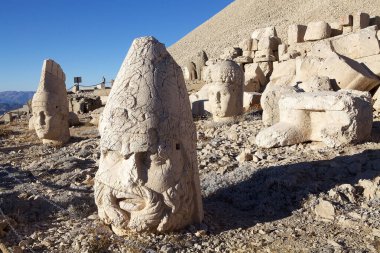 Thrones in the East Terrace of Mount Nemrut in southeatern Turkey. Mount Nemrut is notable for the summit where a number of large statues are erected around what is assumed to be a royal tomb from the 1st century BC.  clipart