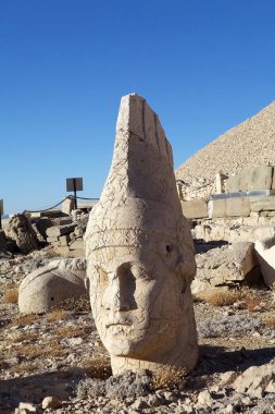 Thrones in the East Terrace of Mount Nemrut in southeatern Turkey. Mount Nemrut is notable for the summit where a number of large statues are erected around what is assumed to be a royal tomb from the 1st century BC.  clipart