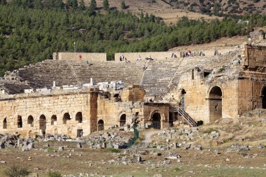 Türkiye 'nin güneybatısındaki Pamukkale' deki Hierapolis arkeoloji sahasındaki tiyatro. Bölge termal kaynak suyunun akışından kalan karbonat mineraliyle ünlüdür. Yunanistan 'ın Hierapolis kenti travertin oluşumunun üzerine inşa edildi