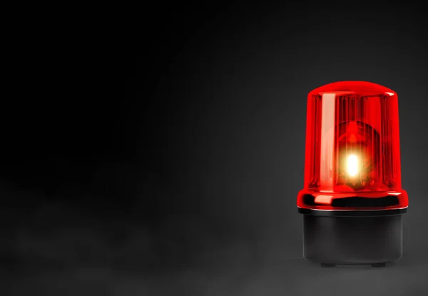 Red siren emergency warning light with black base that are currently on with black background with smoke with clipping path