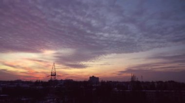 Beautiful sunset sky over the city. Clouds of pink, orange, red and purple. Cloud horizon sun sets. Sunrise and dawn. Kyiv. Ukraine. Gorgeous panorama scenic. Colorful cloudy color nature background