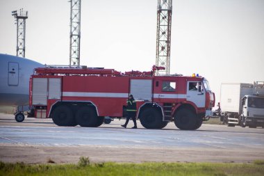 Red fire truck at the airport. Outdoor transportation car. Airport fire engine on the runway. Kyiv, Ukraine - June 27, 2020