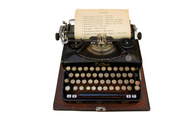 Old typewriter Erika isolated on white background. Retro vintage typewriter and a blank sheet of paper inserted. German black type writer top view. Seidel Naumann. Kyiv, Ukraine - june 2020.
