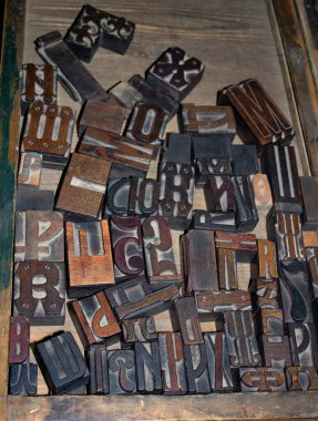 Set of old wooden letters for typography. Vintage background. Letter stamp for printing books. Letterpress alphabet with wooden blocks. Collection of various wood type-setting letter block