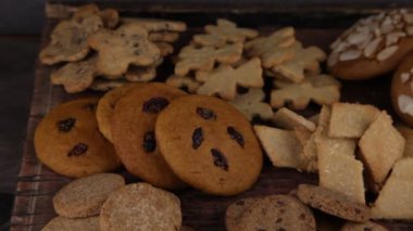 Set of different homemade cookies. Cookie close-up. Background from delicious pastries. Cookies with coconut, mishdal, chocolates, raisins, lingonberries. Round rhombuses, bears flowers shapes.
