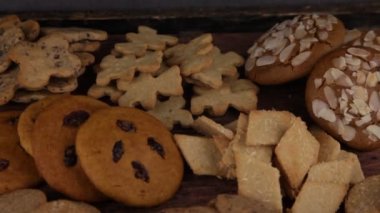 Set of different homemade cookies. Cookie close-up. Background from delicious pastries. Cookies with coconut, mishdal, chocolates, raisins, lingonberries. Round rhombuses, bears flowers shapes.