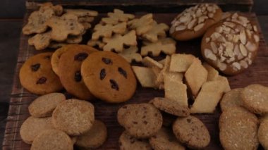 Set of different homemade cookies. Cookie close-up. Background from delicious pastries. Cookies with coconut, mishdal, chocolates, raisins, lingonberries. Round rhombuses, bears flowers shapes.