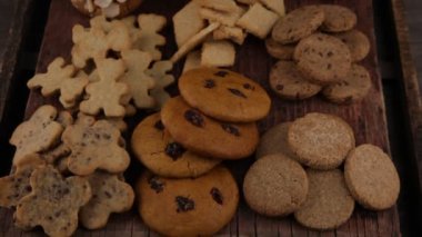 Set of different homemade cookies. Cookie close-up. Background from delicious pastries. Cookies with coconut, mishdal, chocolates, raisins, lingonberries. Round rhombuses, bears flowers shapes.
