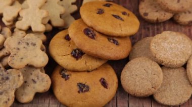 Set of different homemade cookies. Cookie close-up. Background from delicious pastries. Cookies with coconut, mishdal, chocolates, raisins, lingonberries. Round rhombuses, bears flowers shapes.