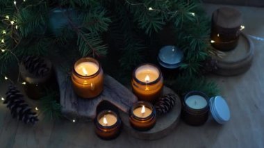 Soya mumları cam kavanozlarda yanar. Evdeki rahatlık. Kahverengi kavanozdaki mum. Koku ve ışık. Kokulu el yapımı mum. Aroma terapisi. Noel ağacı ve kış havası. Sıcak ev dekorasyonu. Şenlikli dekorasyon.