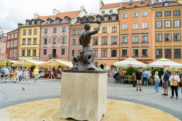 stock image Mermaid monument. Old city. Warsaw Poland. Multicolored houses. Empty street without tourists. Outdoor Europe. Warsaw, Poland - August 1, 2023.