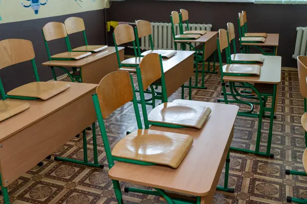 Furniture at school. Empty class. Wooden desks with chair. Double table