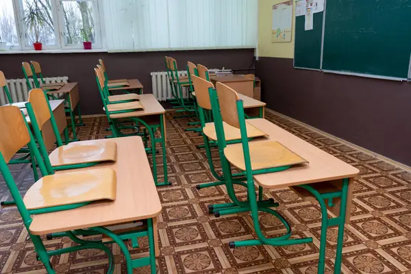 Furniture at school. Empty class. Wooden desks with chair. Double table