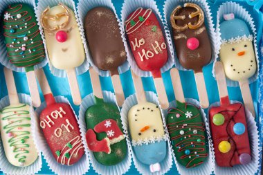 Noel tatlısı. Tatlı yemek. Dondurma şeklinde çubuk üzerinde cheesecake. Çocuklar kışın ısmarlar. Şeker Noel ağacı, kardan adam, geyik ve Noel Baba. Zencefilli kurabiye..