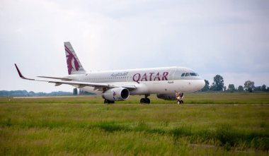 Passenger plane on the airport runway. QATAR Airlines aircraft. Ukraine, Kyiv -28 May 2021. clipart