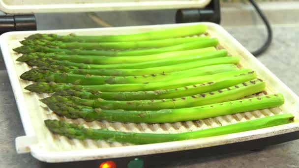 グリーンアスパラガスをグリル グリルの新鮮な春の野菜料理 ホットスチームの準備 — ストック動画