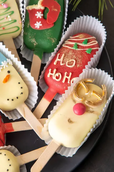 stock image Winter sweet food. Cheesecake stick ice cream. Candy snowman, deer. Gingerbread cookies.