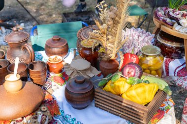 Ukrayna sokak yemek festivali. Çamur tenceresi masada. Sebzeler sonbahar pikniğini hasat ediyor.